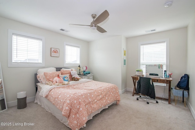 carpeted bedroom with a ceiling fan, baseboards, and visible vents