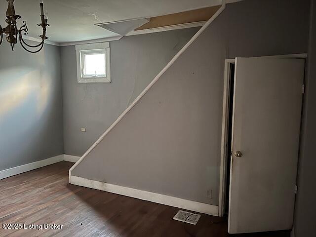 below grade area featuring baseboards and wood finished floors