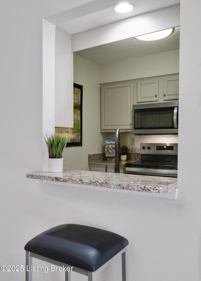 kitchen featuring stainless steel appliances and light countertops