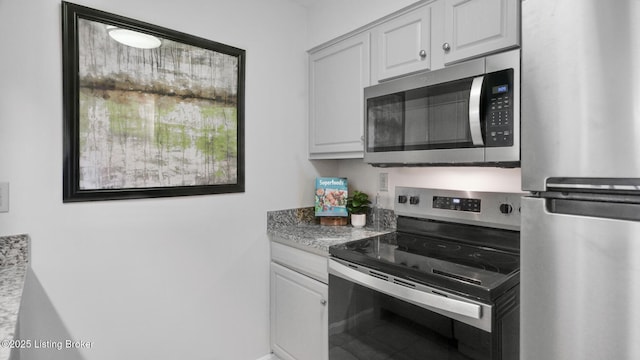 kitchen with appliances with stainless steel finishes and white cabinetry