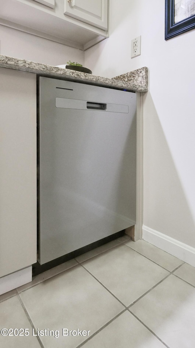 interior details with dishwasher, light stone counters, and baseboards