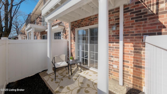 view of patio / terrace with fence and a balcony