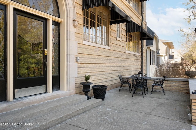 view of patio with entry steps and outdoor dining area