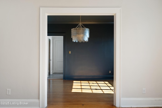 interior space with baseboards and wood finished floors