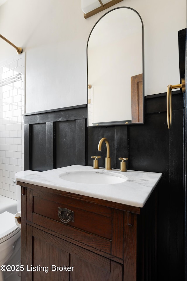 bathroom with  shower combination, vanity, and toilet