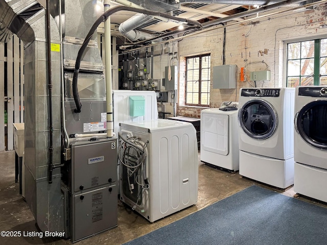 clothes washing area with washing machine and dryer