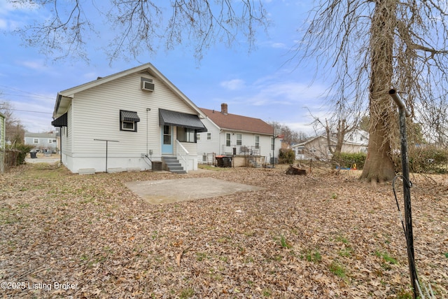 rear view of property with entry steps, a patio area, and a wall mounted air conditioner