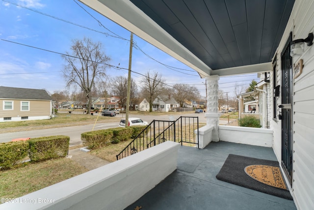 balcony with covered porch and a residential view