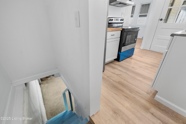 kitchen featuring white cabinetry, baseboards, electric range oven, open shelves, and light wood finished floors