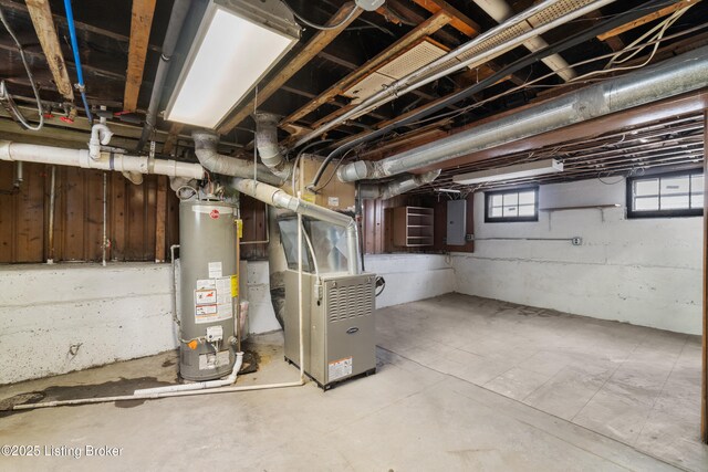 basement featuring gas water heater, electric panel, and heating unit