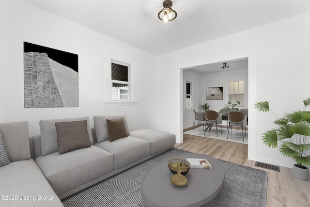 living area featuring wood finished floors and visible vents