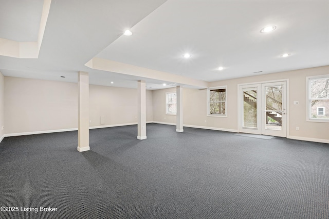 basement with a wealth of natural light, dark colored carpet, baseboards, and recessed lighting