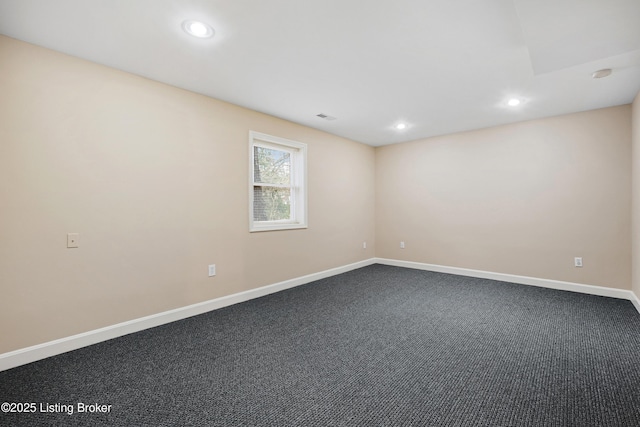 spare room with recessed lighting, visible vents, dark carpet, and baseboards