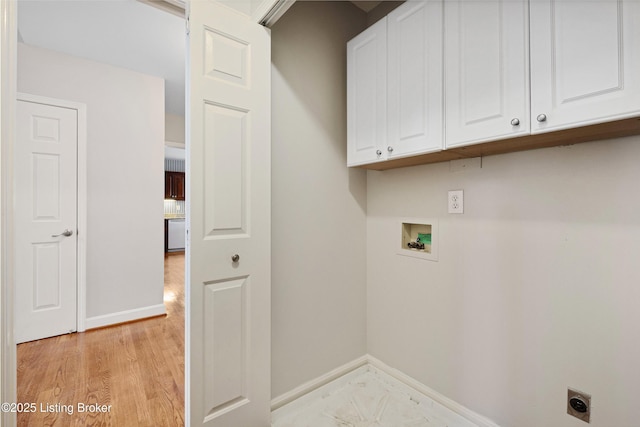 washroom with cabinet space, hookup for a washing machine, baseboards, and hookup for an electric dryer