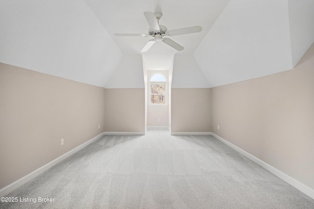 additional living space with carpet floors, lofted ceiling, ceiling fan, and baseboards