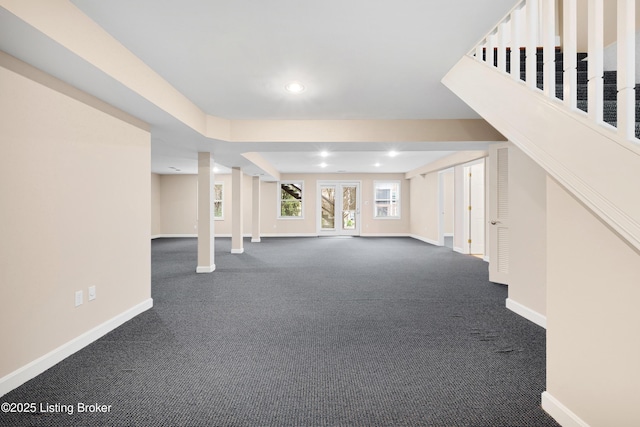 basement featuring recessed lighting, dark carpet, and baseboards