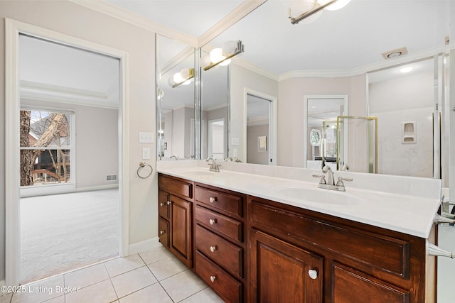 bathroom featuring double vanity, ornamental molding, a sink, and tile patterned floors