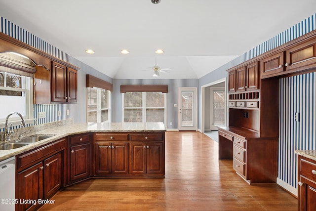 kitchen with lofted ceiling, a sink, a ceiling fan, light wood-style floors, and dishwasher