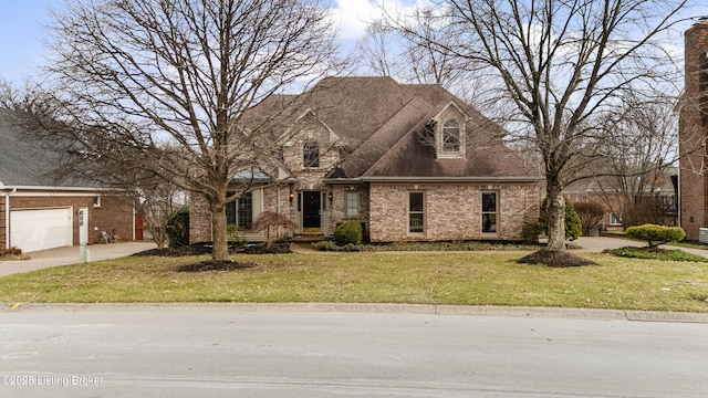 view of front facade with a front lawn, roof with shingles, an attached garage, and brick siding