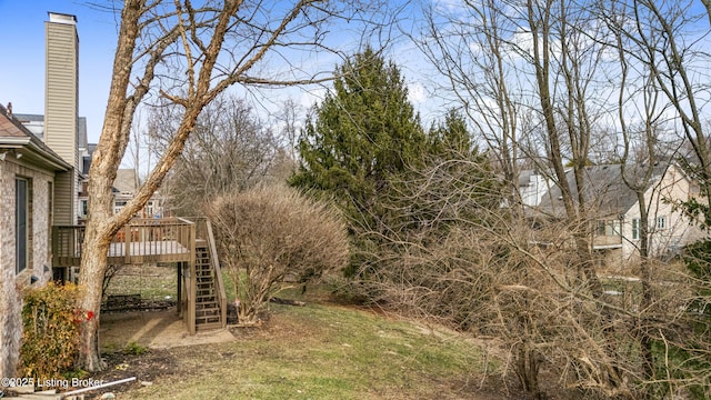 view of yard with stairs and a wooden deck