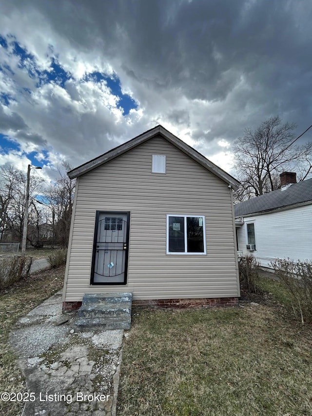 rear view of property with crawl space and a yard