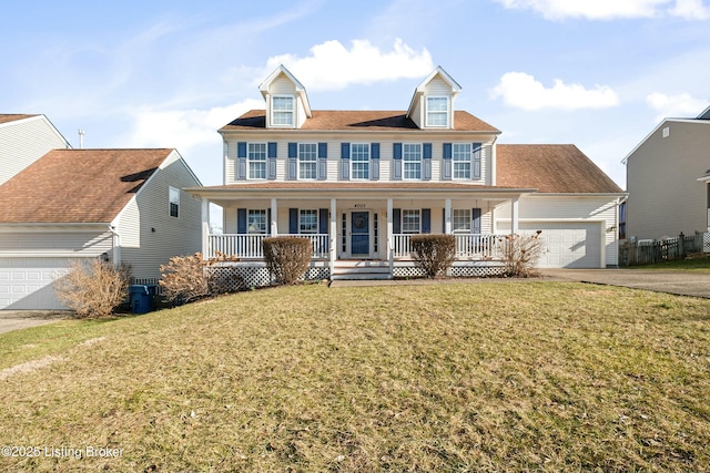 view of front of house with a garage, a front yard, covered porch, and driveway