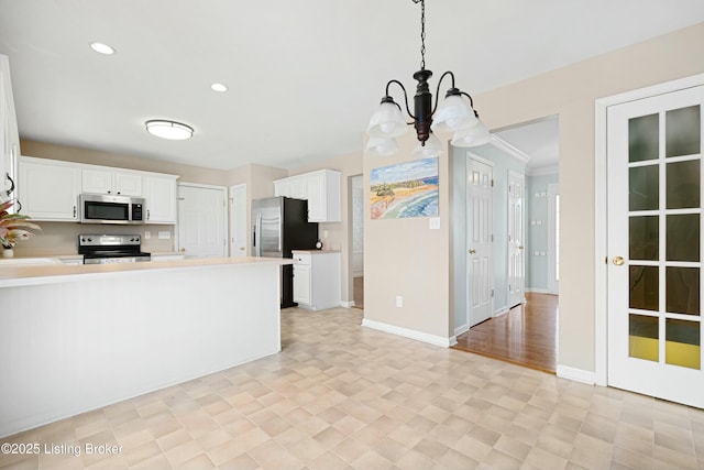 kitchen featuring decorative light fixtures, stainless steel appliances, light countertops, white cabinetry, and recessed lighting