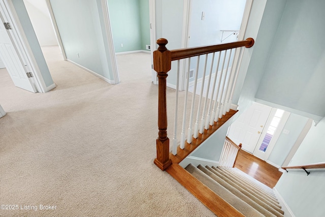 stairway featuring carpet flooring, visible vents, and baseboards