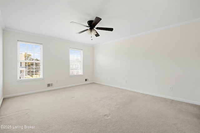 spare room featuring visible vents, crown molding, light carpet, and baseboards