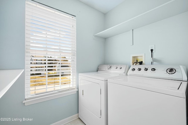 laundry room with laundry area, washer and clothes dryer, and baseboards