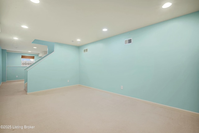 below grade area with recessed lighting, visible vents, and light carpet