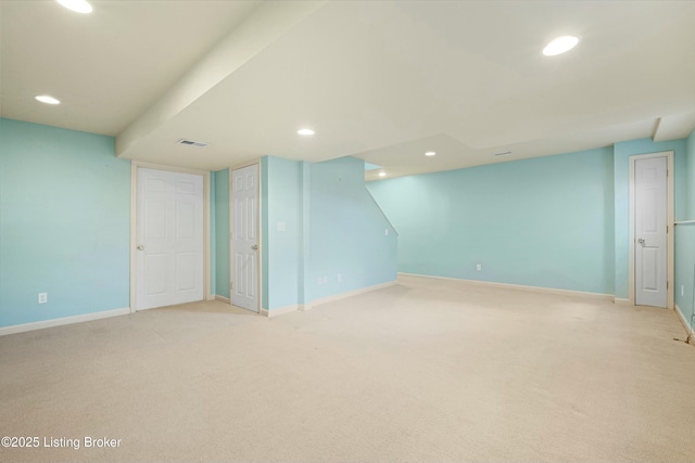 finished below grade area featuring baseboards, light colored carpet, visible vents, and recessed lighting