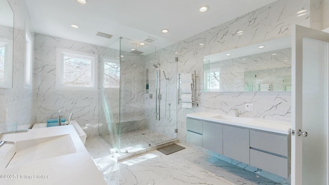 full bath featuring a marble finish shower, tile walls, marble finish floor, and stone wall