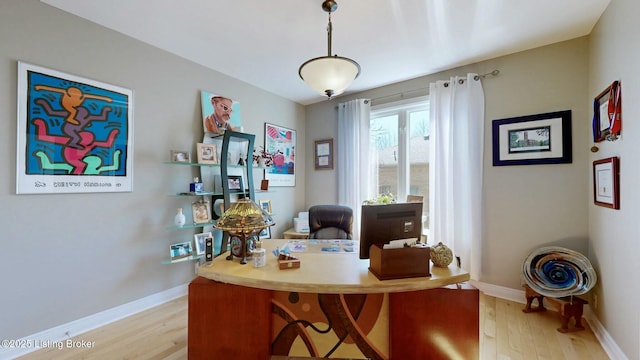 office with light wood-style floors and baseboards