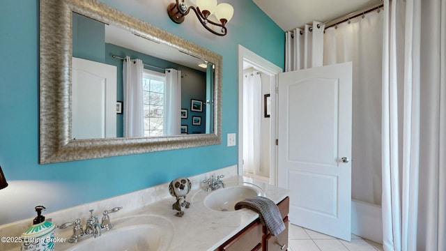 full bathroom featuring tile patterned flooring, double vanity, a shower with shower curtain, and a sink