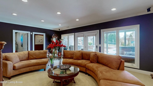 living room with recessed lighting, light colored carpet, and baseboards