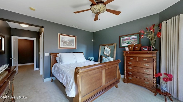 bedroom with light carpet, visible vents, a ceiling fan, and baseboards