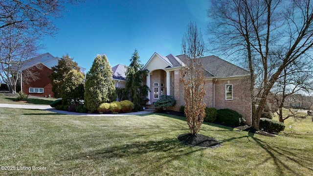 view of front of house with brick siding and a front lawn