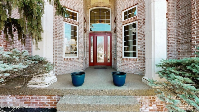 property entrance featuring brick siding