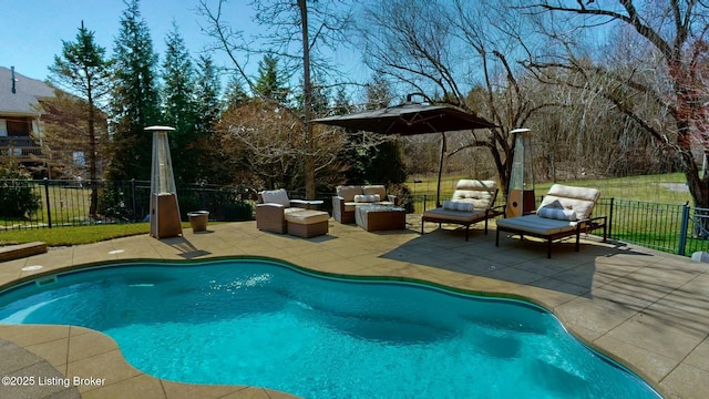 view of swimming pool featuring a patio area, an outdoor living space, a fenced in pool, and fence