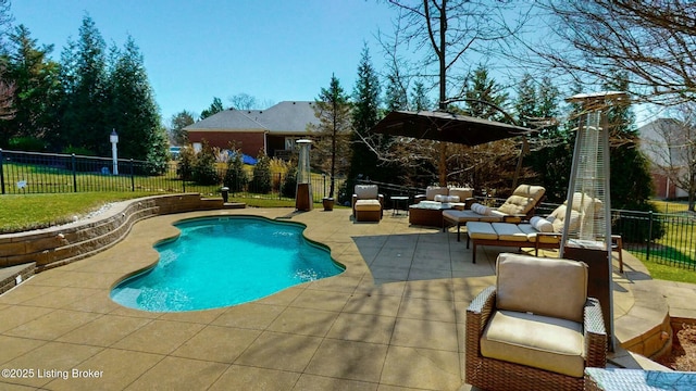 view of pool featuring an outdoor living space, a fenced backyard, a fenced in pool, and a patio