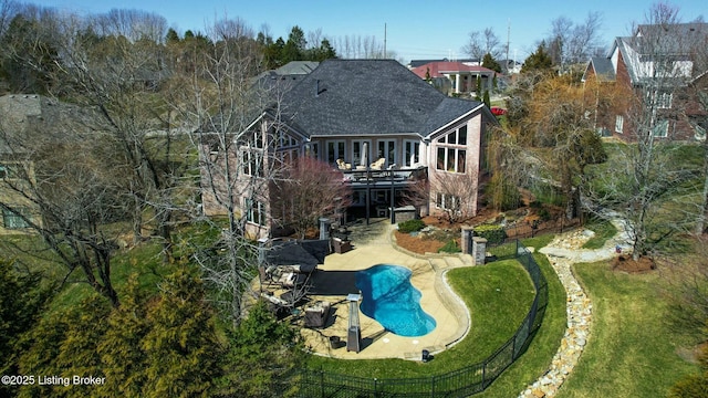 back of house with a patio area, a deck, a shingled roof, and a yard