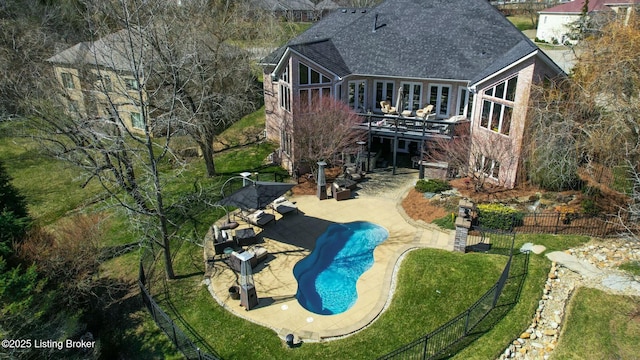 exterior space featuring a fenced in pool, fence, roof with shingles, a lawn, and a patio area