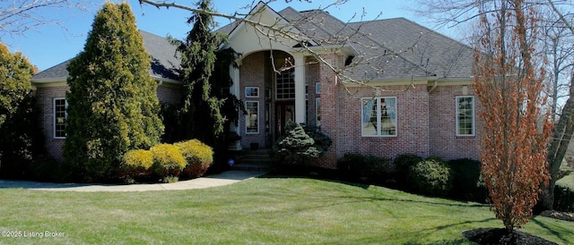 view of front of house with brick siding and a front yard