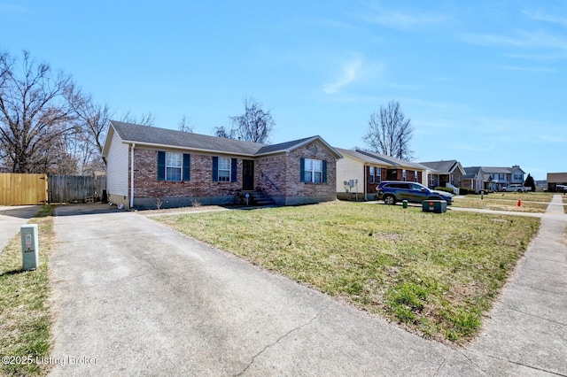 single story home featuring brick siding, a front yard, and fence