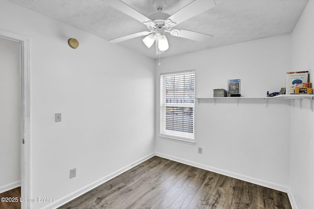 empty room with baseboards, a textured ceiling, a ceiling fan, and wood finished floors