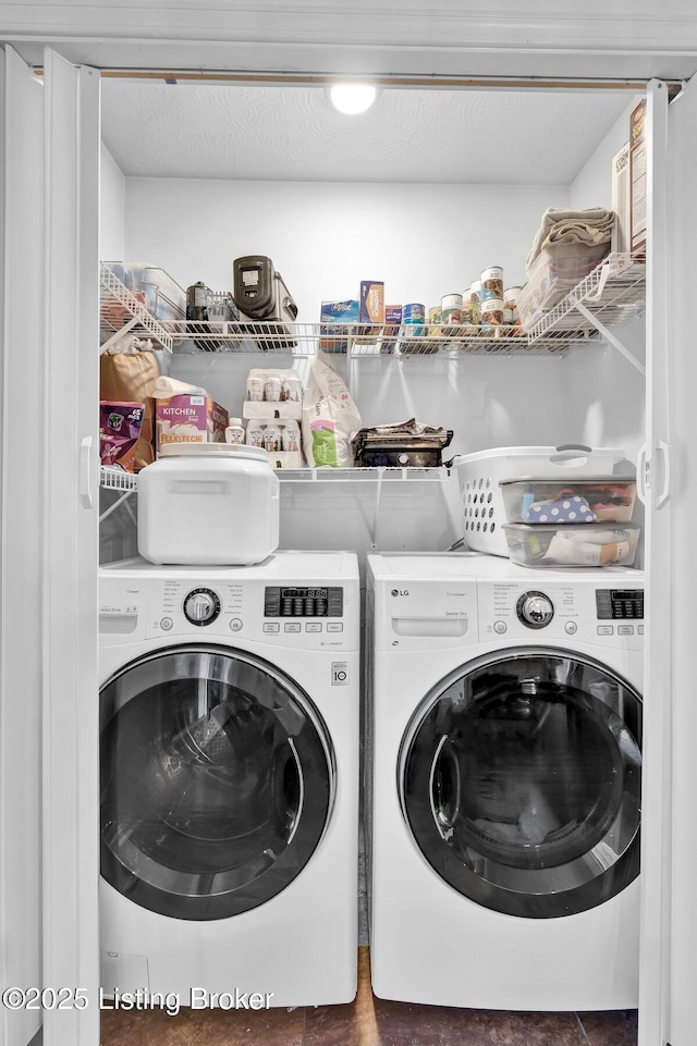 laundry area with washer and dryer, laundry area, and a textured ceiling