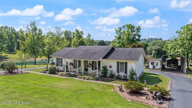 single story home with a front lawn, aphalt driveway, and a carport