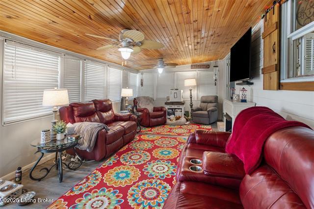 living area featuring wood finished floors, wood ceiling, and a ceiling fan