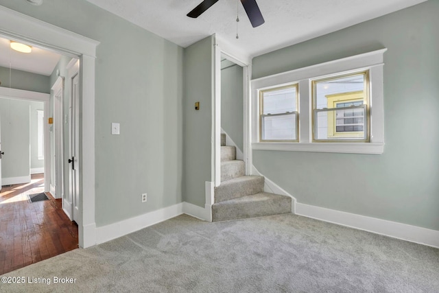 interior space featuring attic access, stairway, visible vents, and baseboards